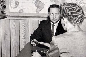 Gilbert Kuhn using classic jewelry sales skills in a store setting in the 1950s